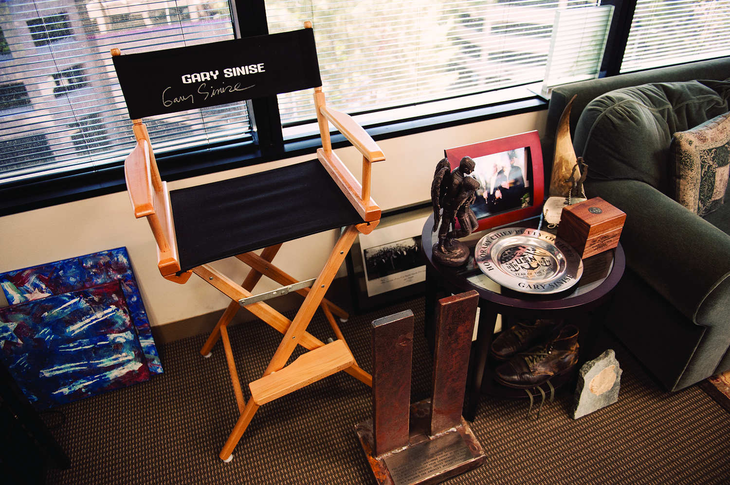 Variety of objects in Gary Sinise's office including an autographed directors chair.