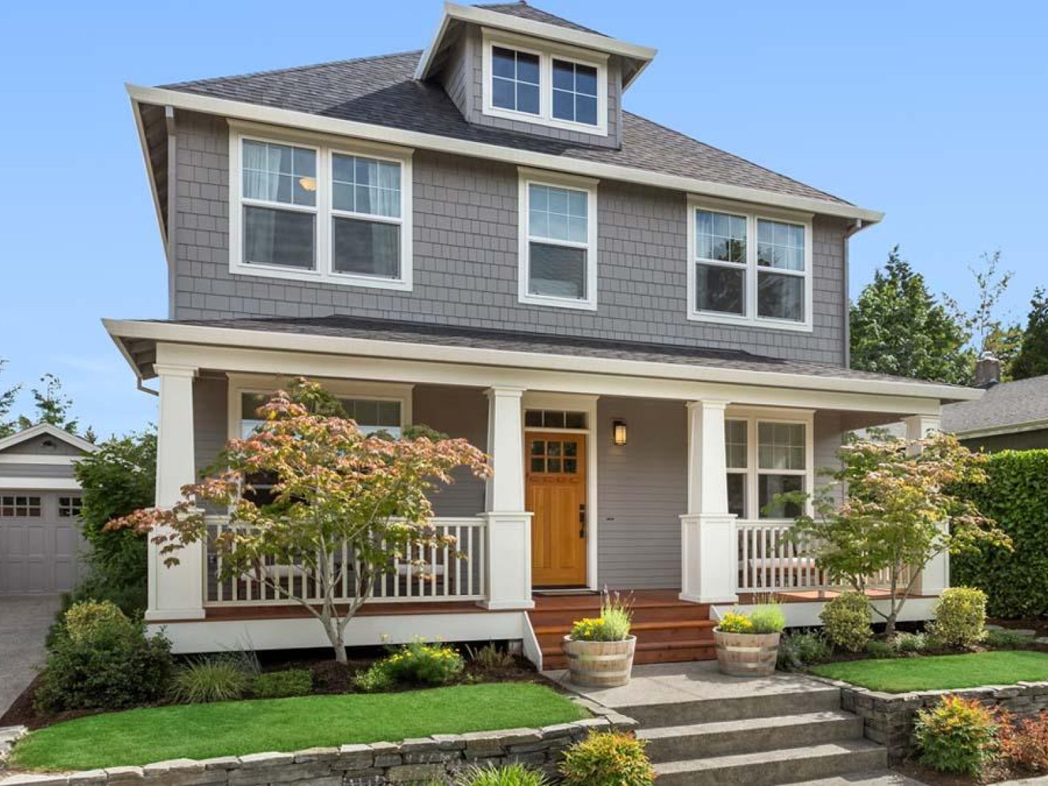 Two story grey house with garage