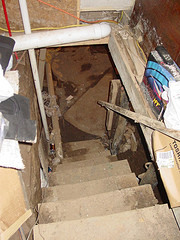 Looking down into a scary, disheveled basement.