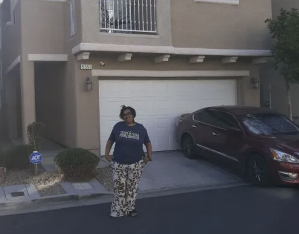 picture of Angelia V. in front of a house
