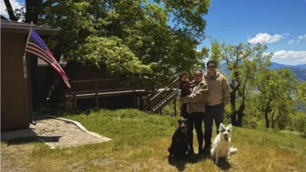 picture of Christopher J. in front of a house